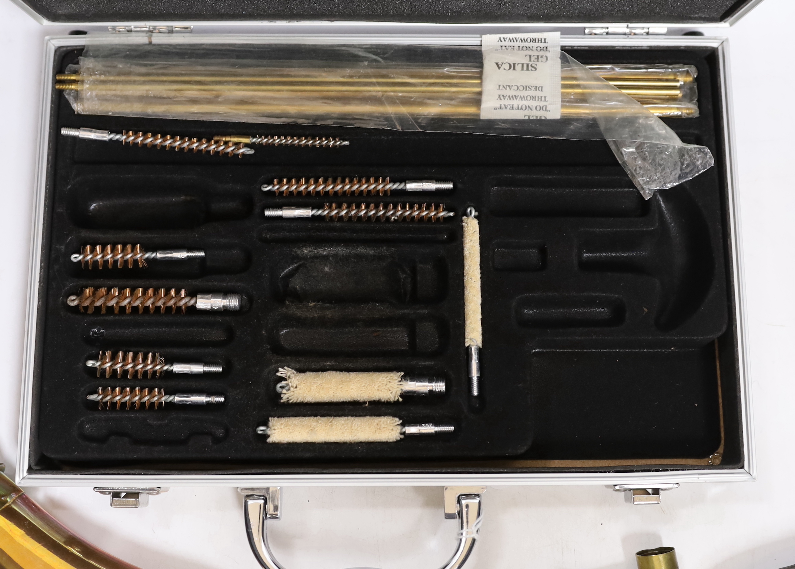 Three copper powder flasks, a leather powder flask, two powder measures and two cases of cleaning tools
